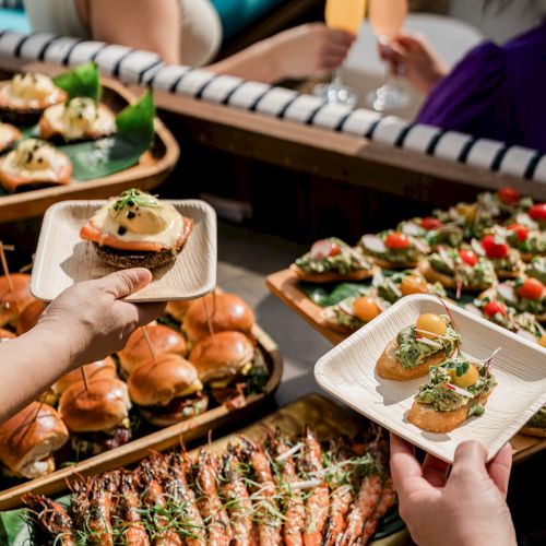 A colorful spread of grilled skewers, veggies, and assorted dishes served on a diner-style table, ready for sharing.